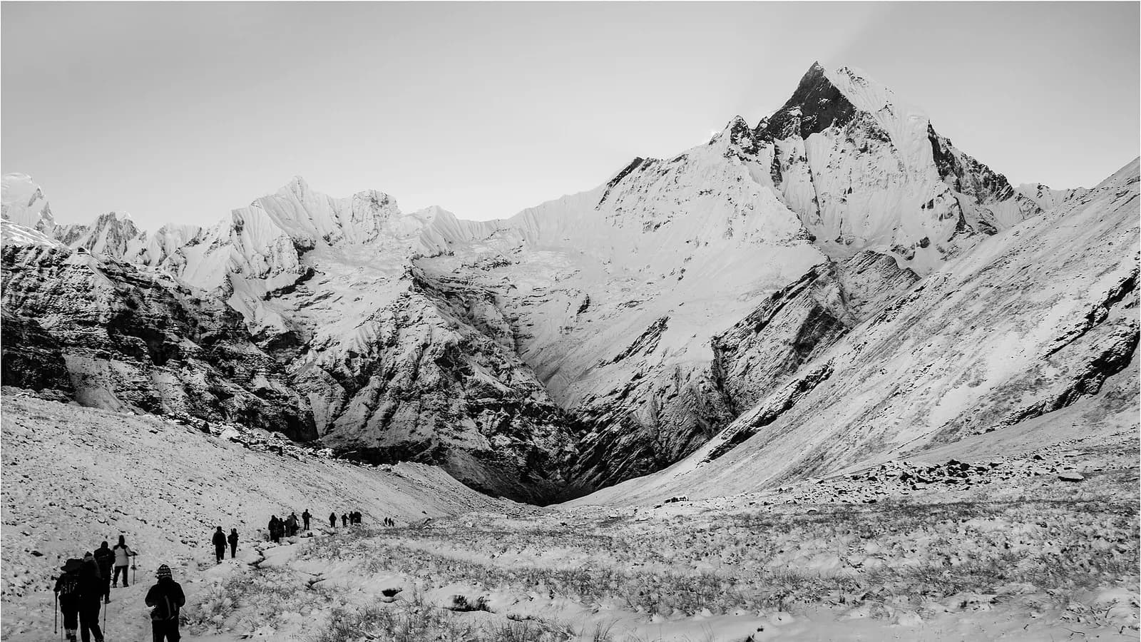 Annapurna Base Camp with snow peaks rising behind the stone lodges