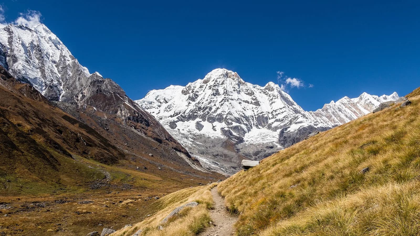 Snow-covered Annapurna I peak rising above ridgelines in the Nepal Himalaya