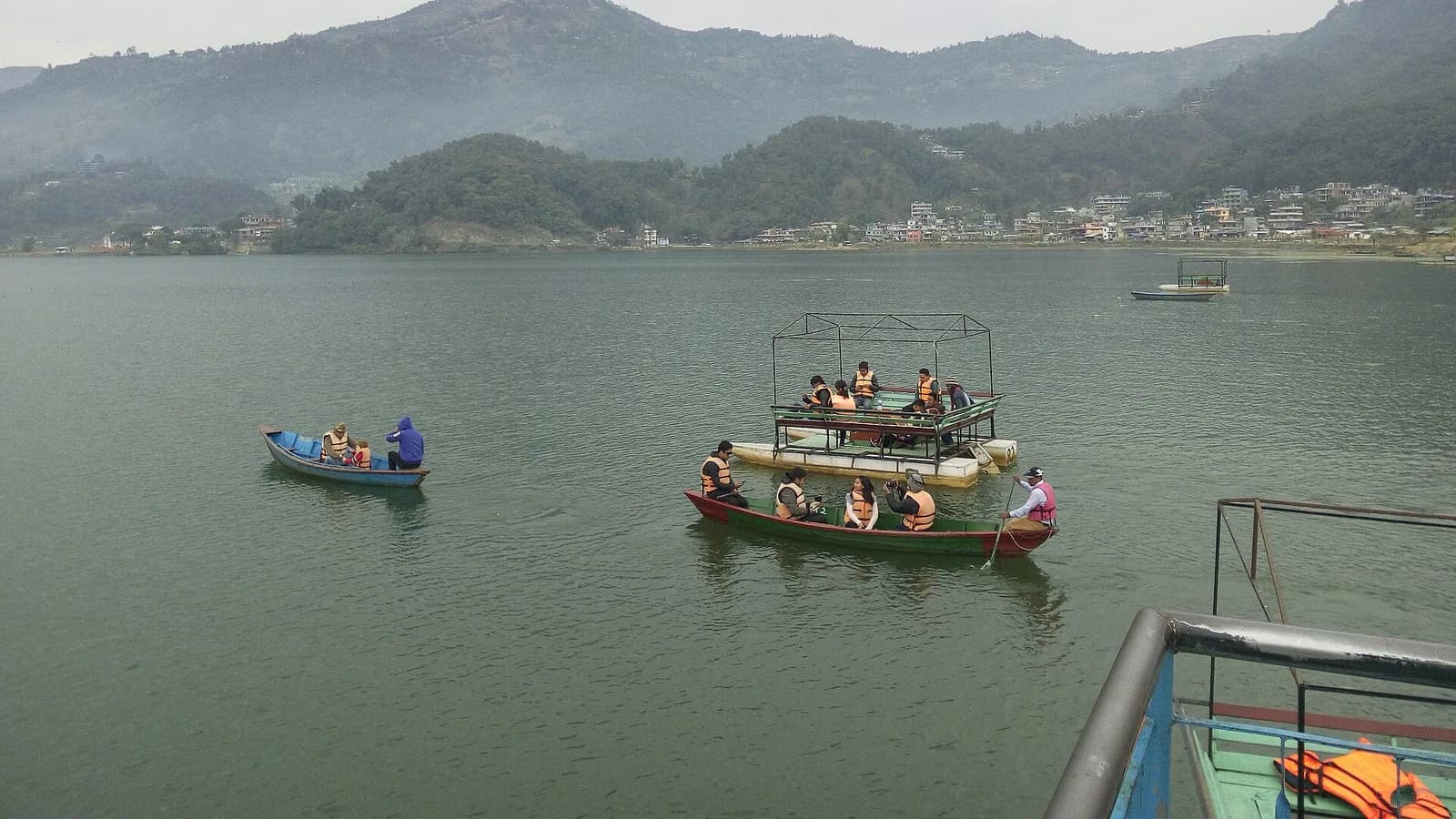 Wooden boats moored on Phewa Lake at Pokhara Lakeside, a classic backpacker base in Nepal
