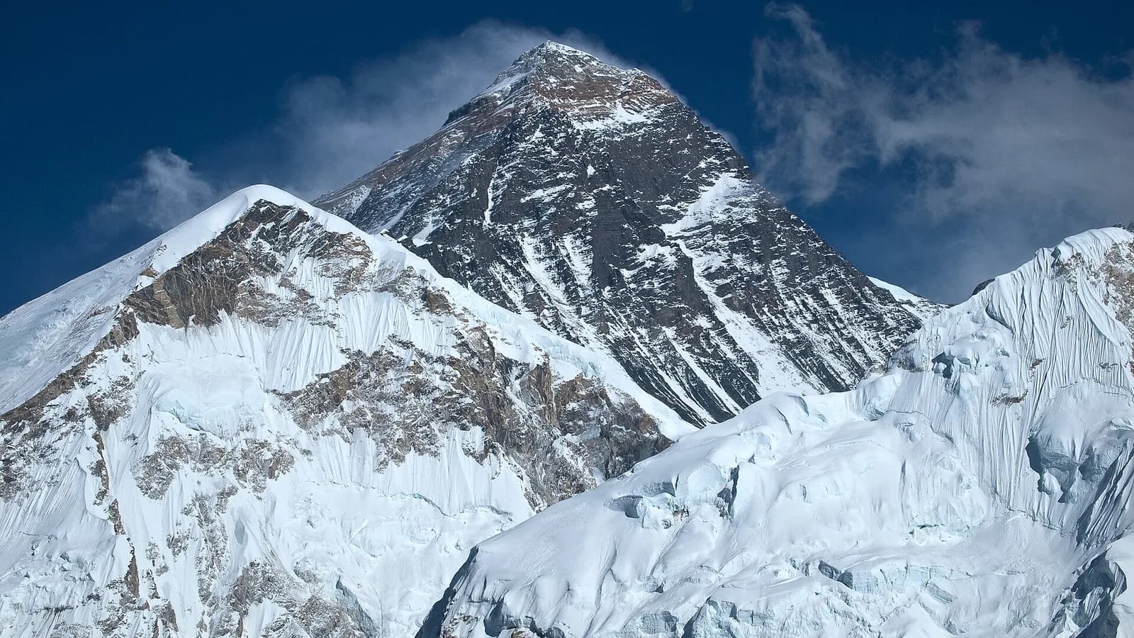 The snow-covered Himalayan range seen from above, with Mount Everest among the high peaks rising over a sea of clouds