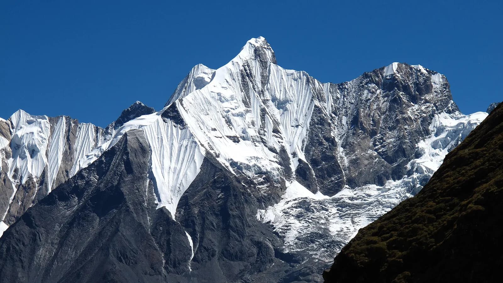 Annapurna Base Camp sanctuary ringed by snow peaks under a clear Himalayan sky
