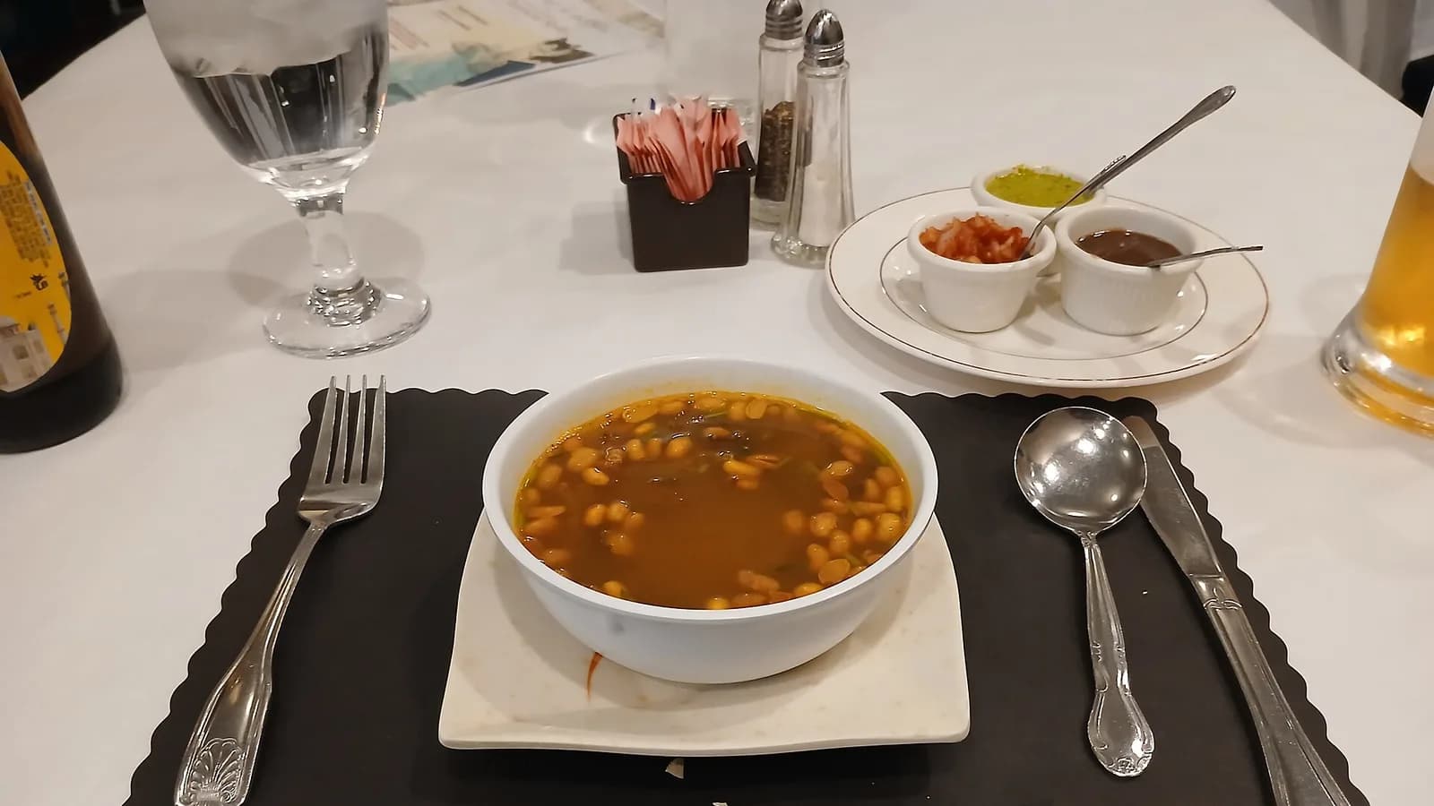A bowl of gundruk soup made from fermented leafy greens, served in a restaurant