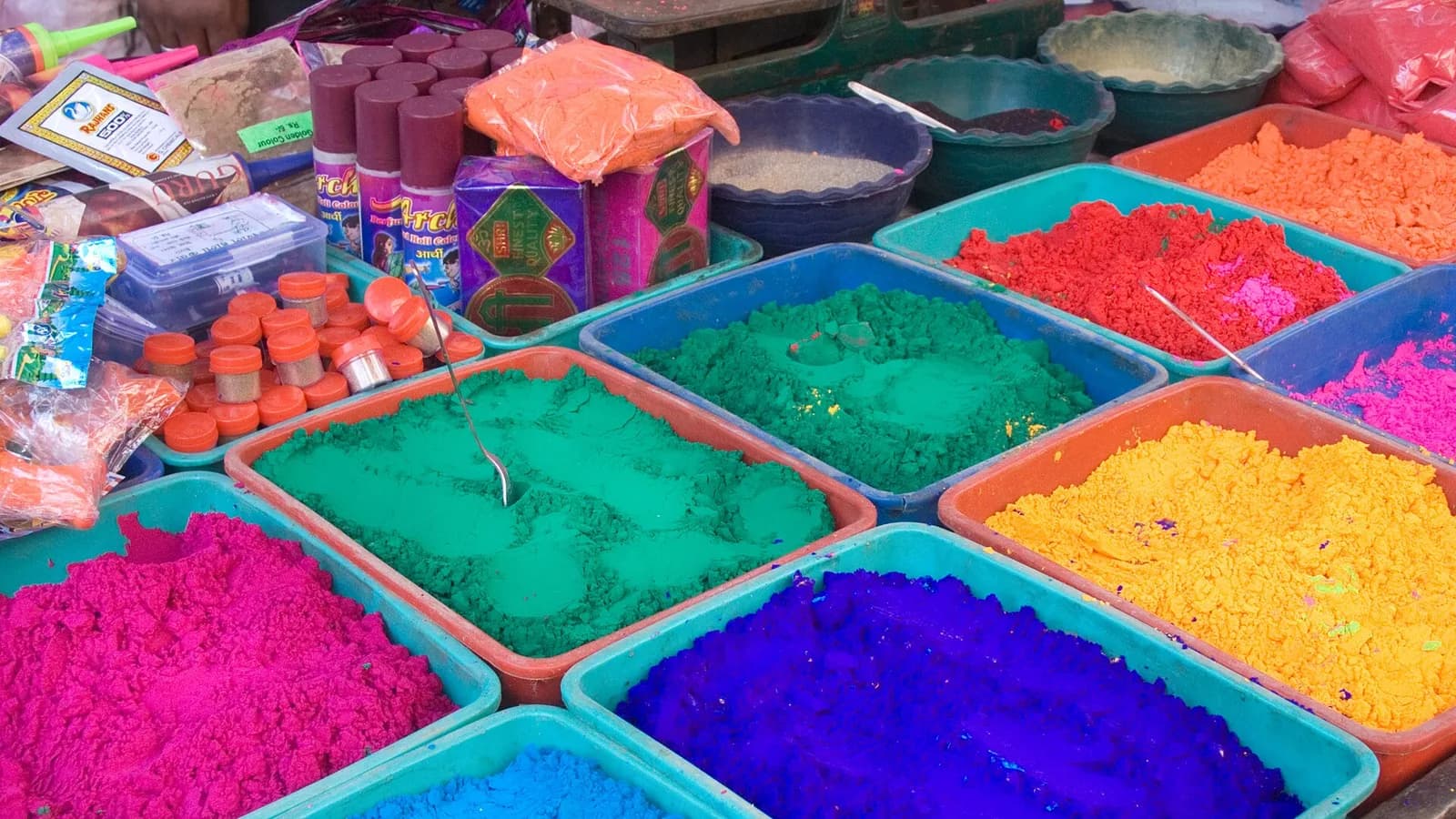 Stalls of brightly colored Holi powder piled in cones