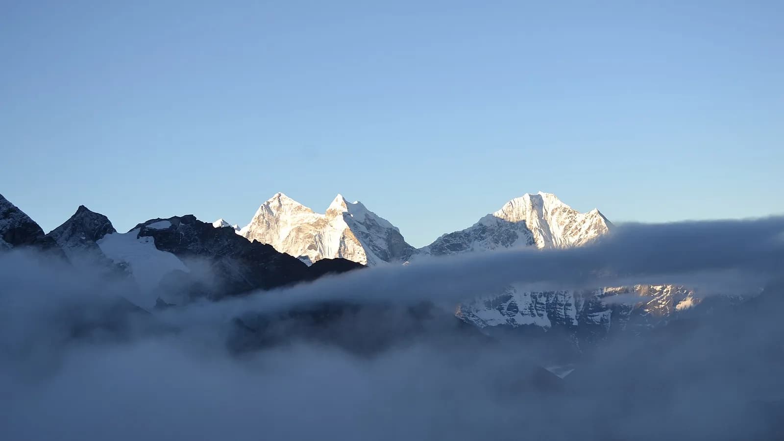 Trekkers on the trail to Everest Base Camp with Himalayan peaks rising in the Khumbu valley