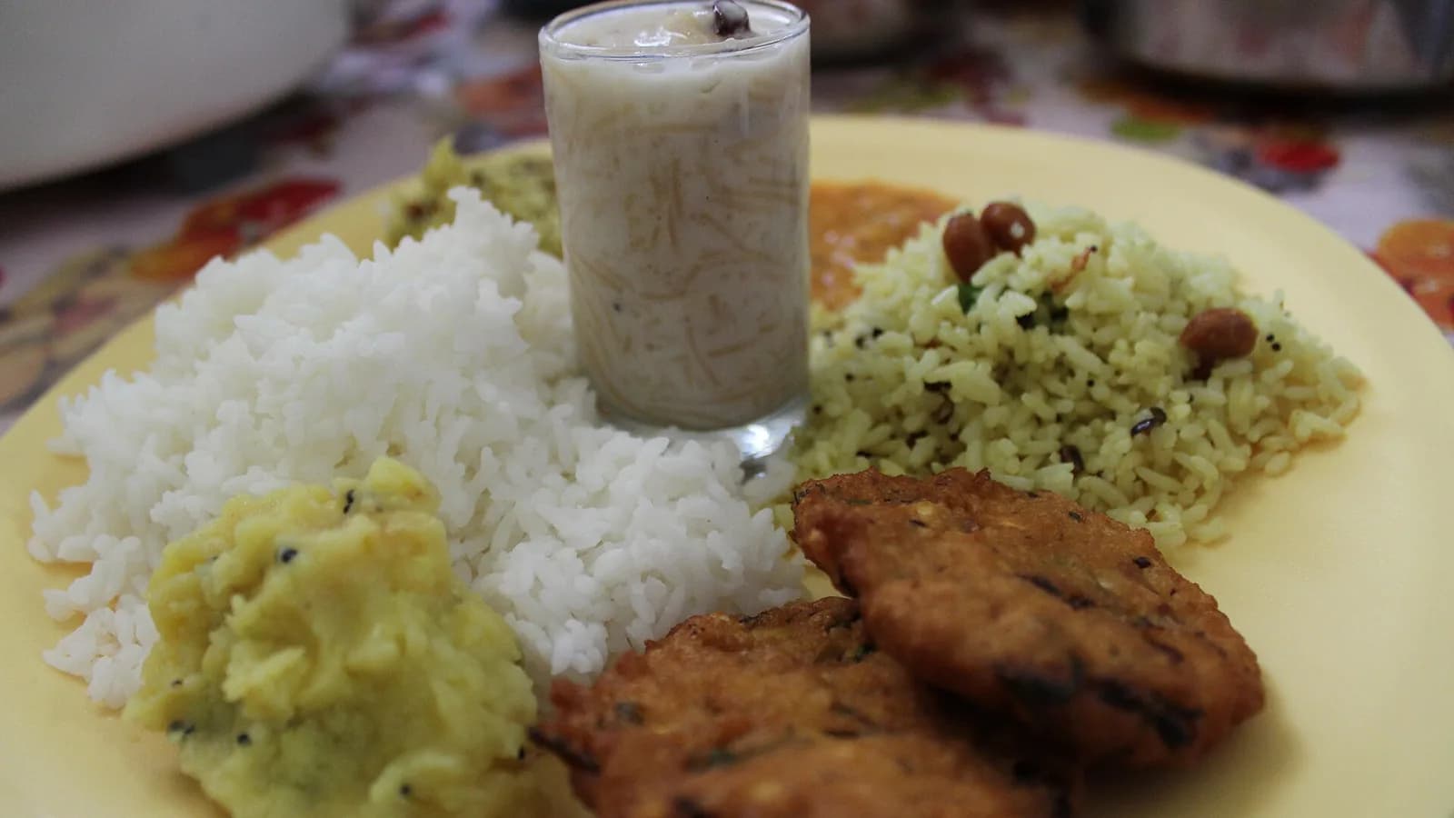 A full thali platter of rice, lentils and fried sides