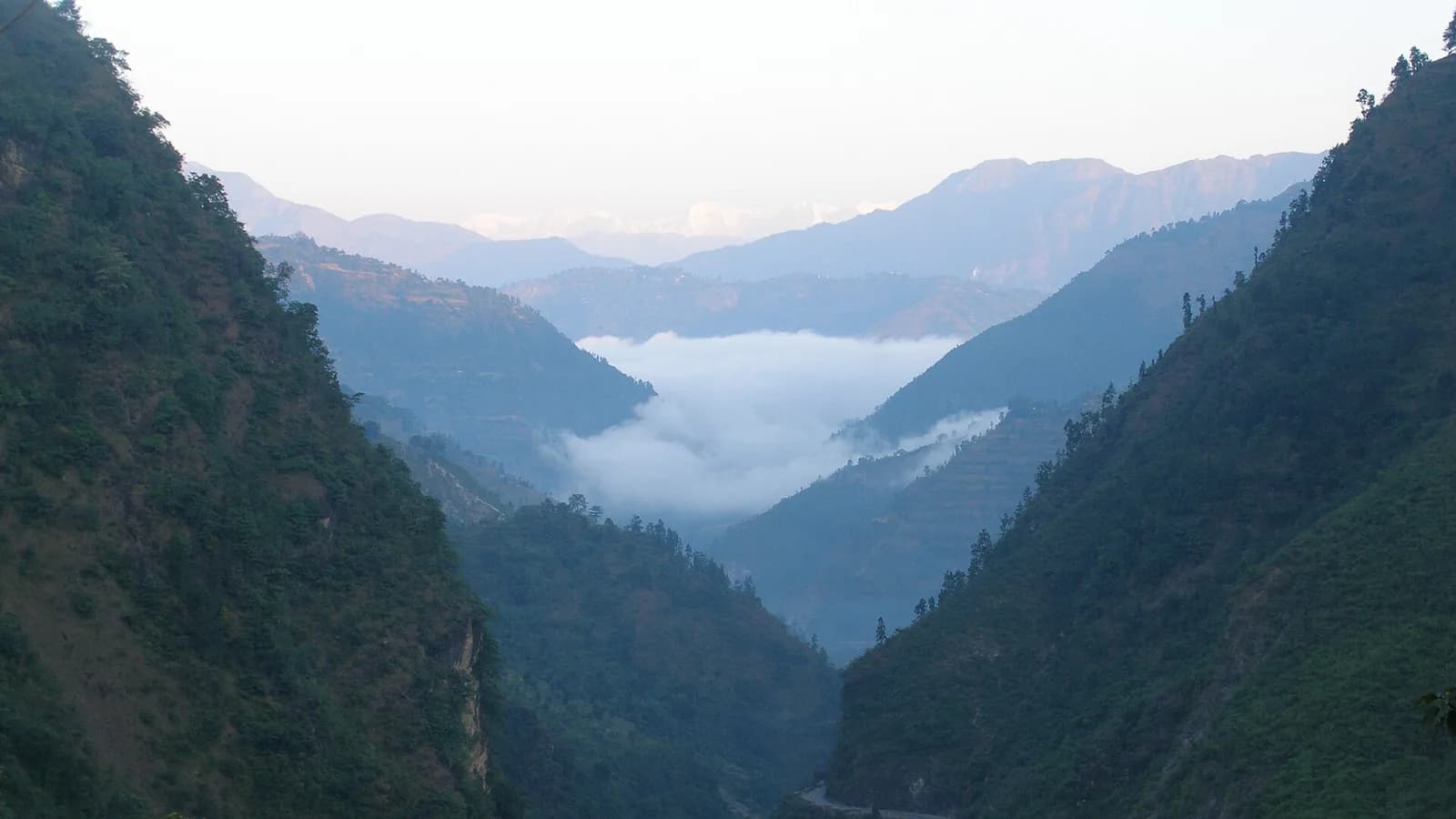 A winding mountain road through the forested Mahabharat Range near Tansen in the Nepali hills
