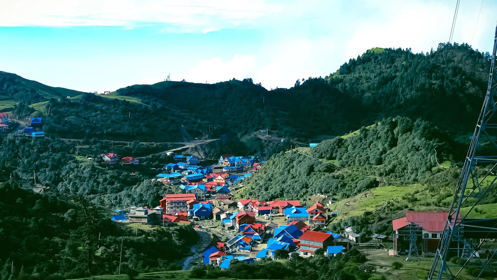The blue-roofed stone houses of Kuri village below the Kalinchok ridge in Dolakha, Nepal