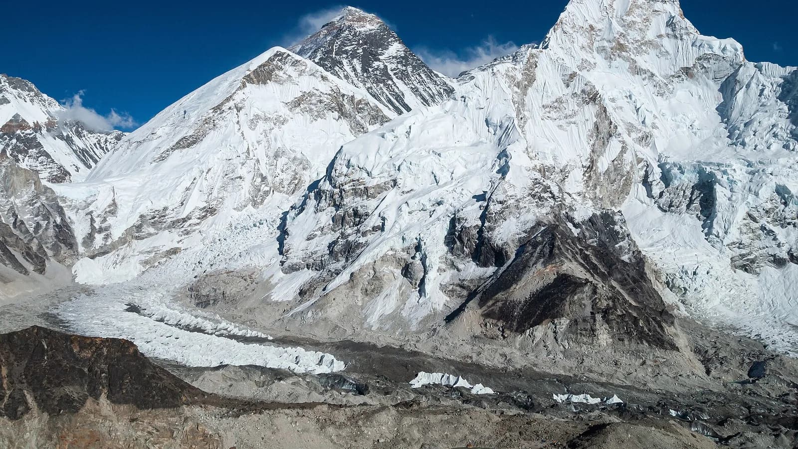 Aerial view of the snow-covered Himalayan range stretching across Nepal, with high peaks rising above the clouds