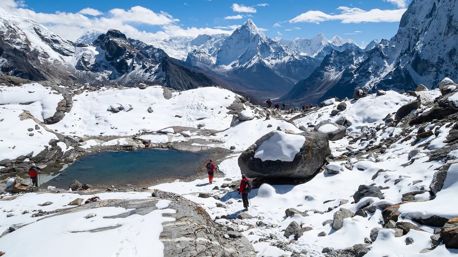 Snow-covered Himalayan peaks in Nepal rising above forested foothills under a clear sky