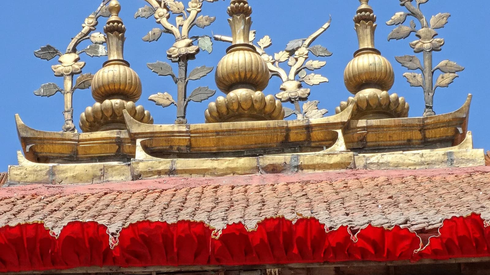Golden finials and a tiled temple roof at Kathmandu Durbar Square in Nepal's capital