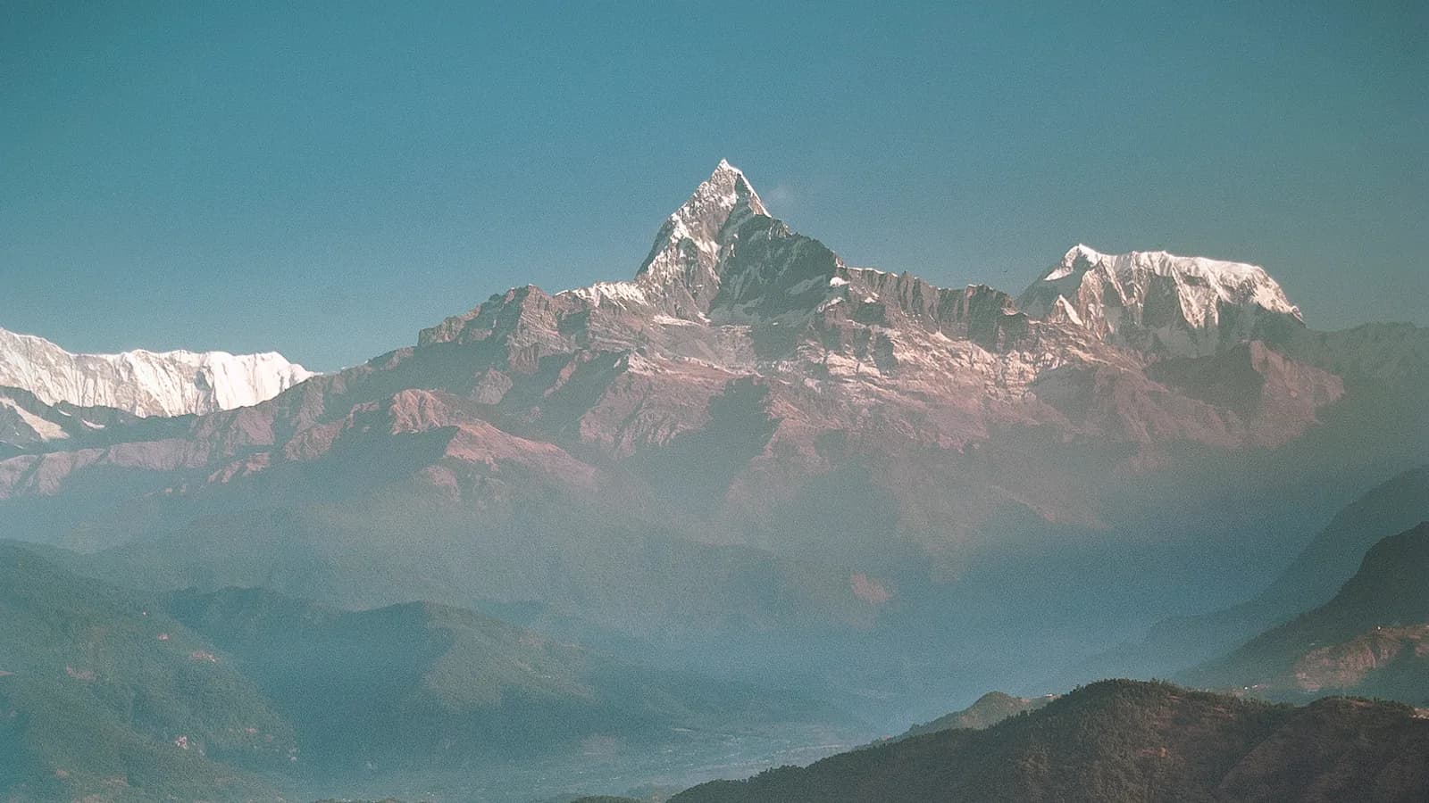 The Annapurna range glowing gold at sunrise, the classic Himalayan view from above Pokhara