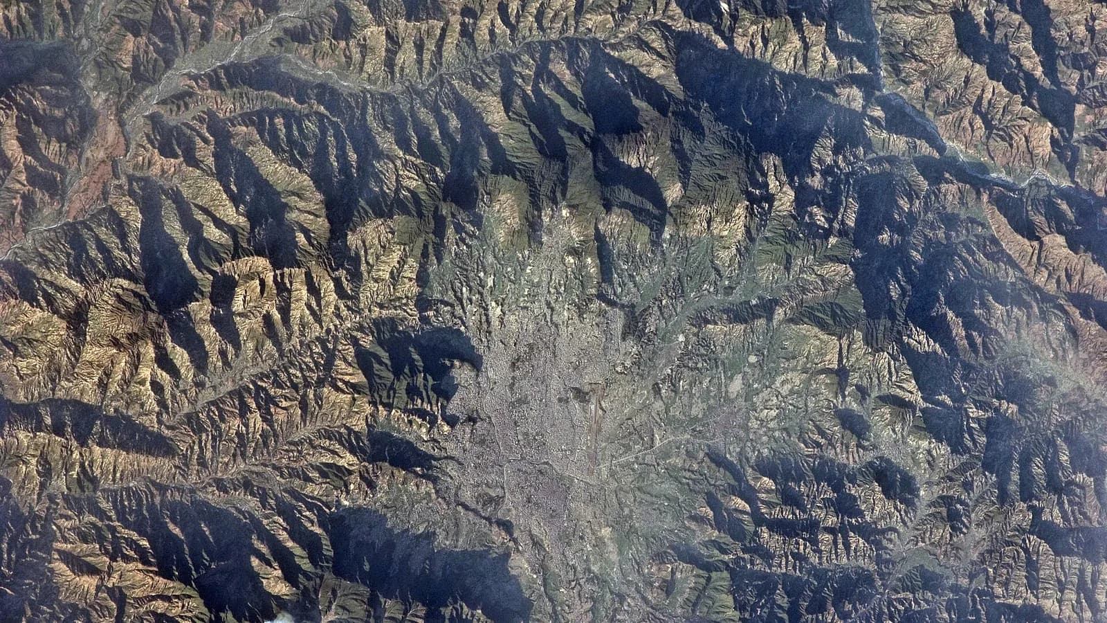 Aerial astronaut photograph of the densely built Kathmandu Valley in Nepal