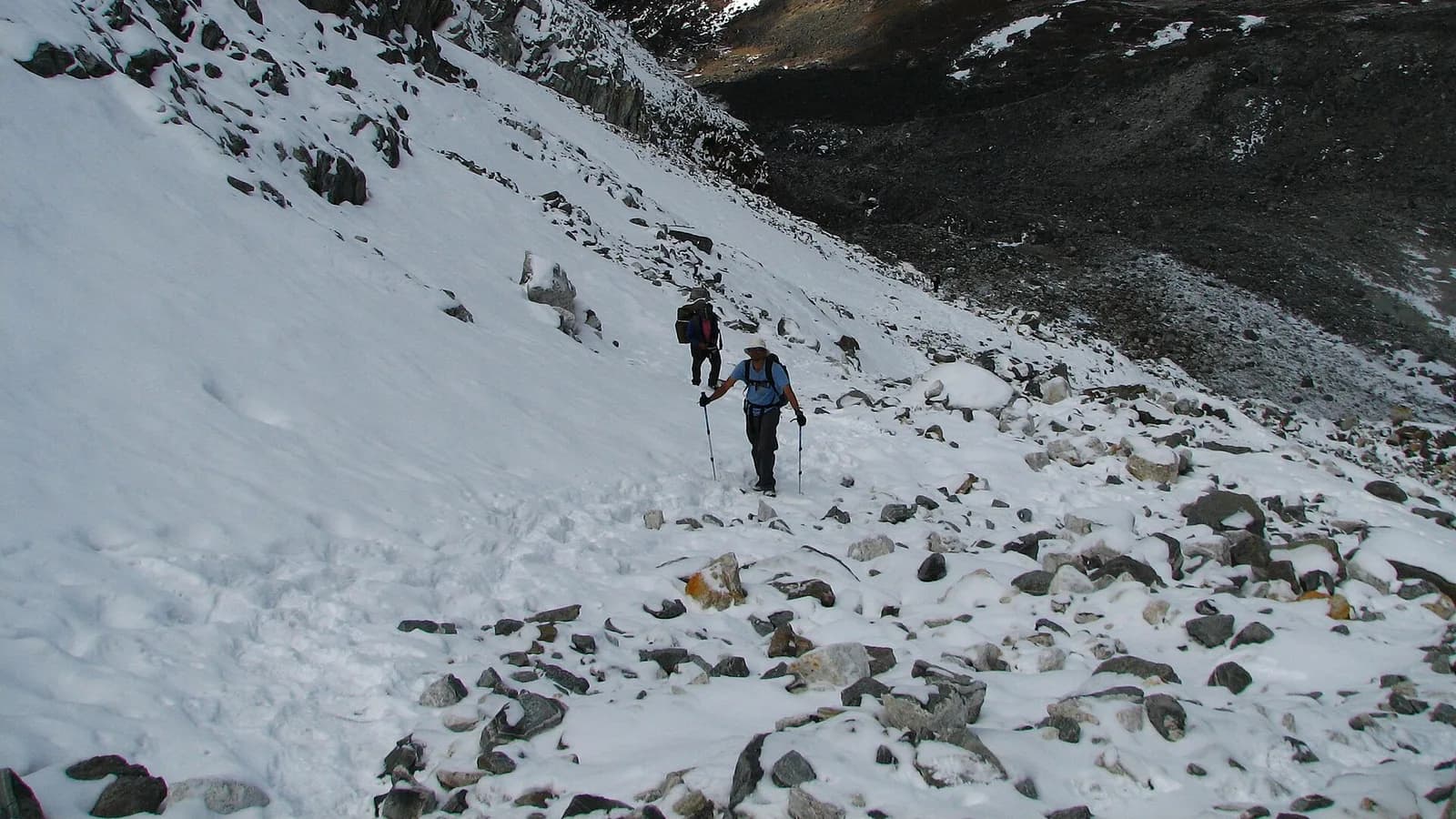 Trekker with a backpack ascending a mountain trail