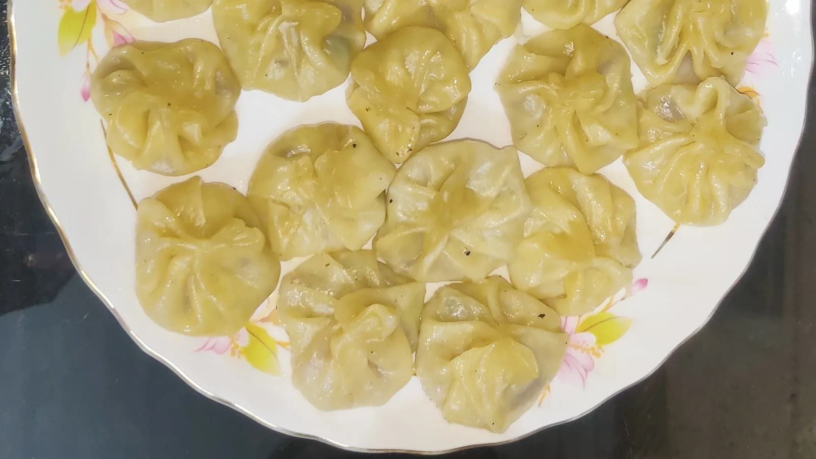 Home-made momo dumplings served with a bowl of red tomato-sesame chutney