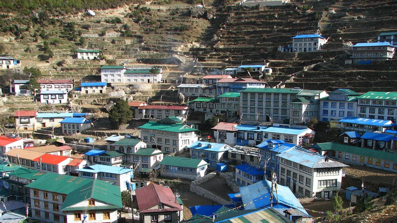 A trail and rough mountain road near Namche in Nepal's Sagarmatha region, surrounded by Himalayan peaks