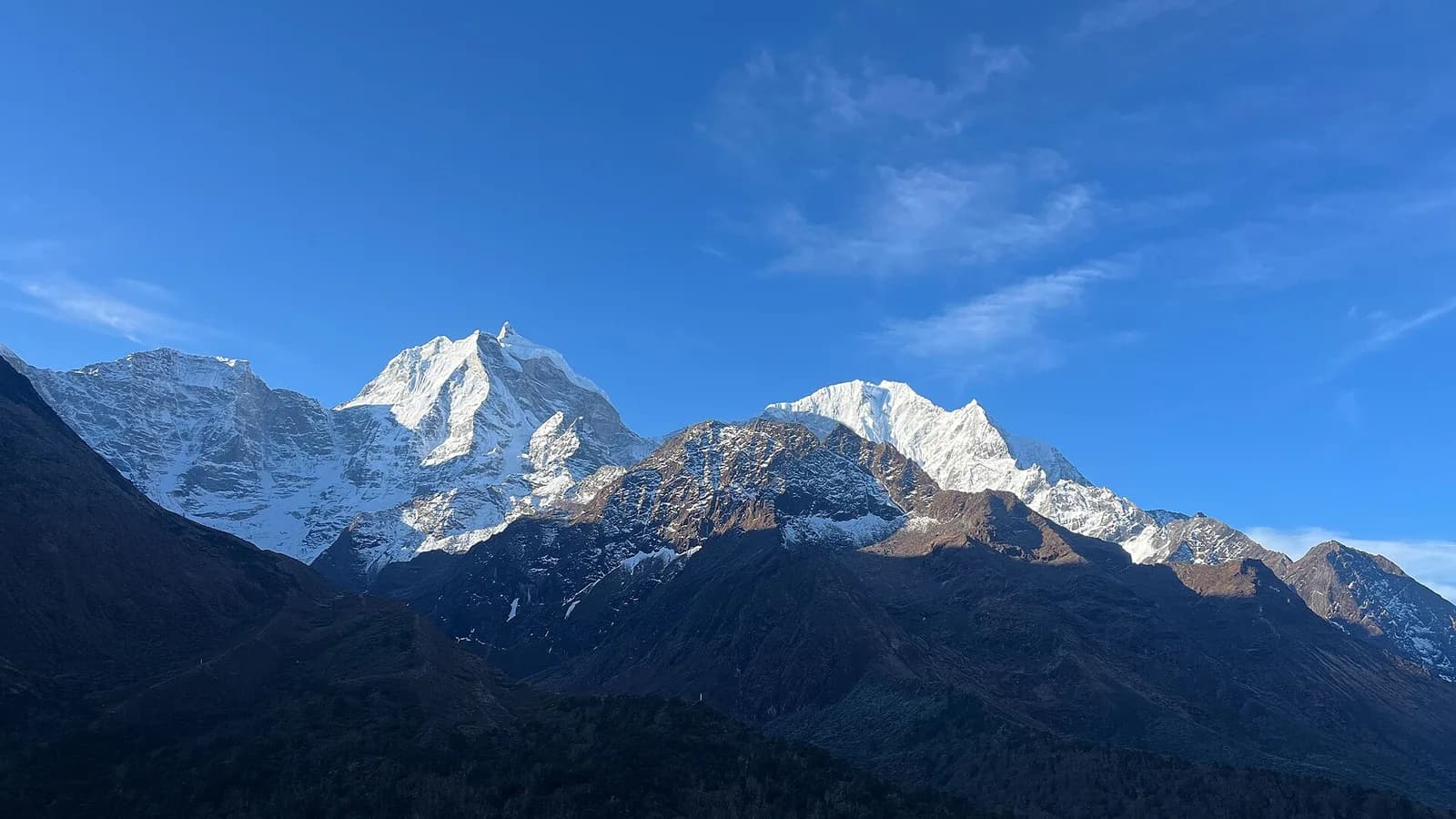 Snow-covered Himalayan peaks photographed from high altitude above the clouds