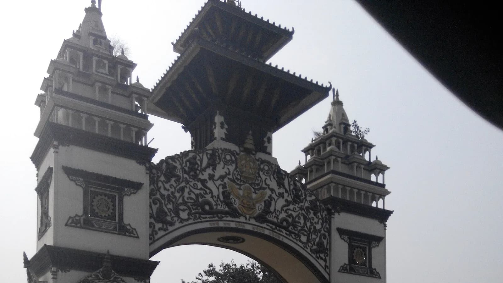 A decorative welcome gateway arch on the Nepal side of a Nepal-India land border crossing